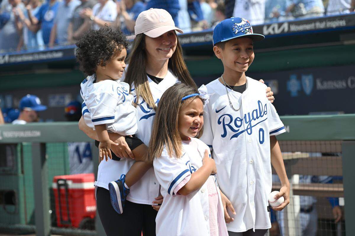 The Gore family pose for photos before the Kansas City Royals take on the Minnesota Twins during the home opening game at Kauffman Stadium on Monday, March 30, 2026, in Kansas City.