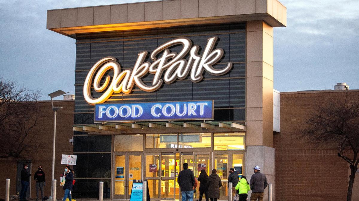 Shoppers head into Oak Park Mall near the food court.
