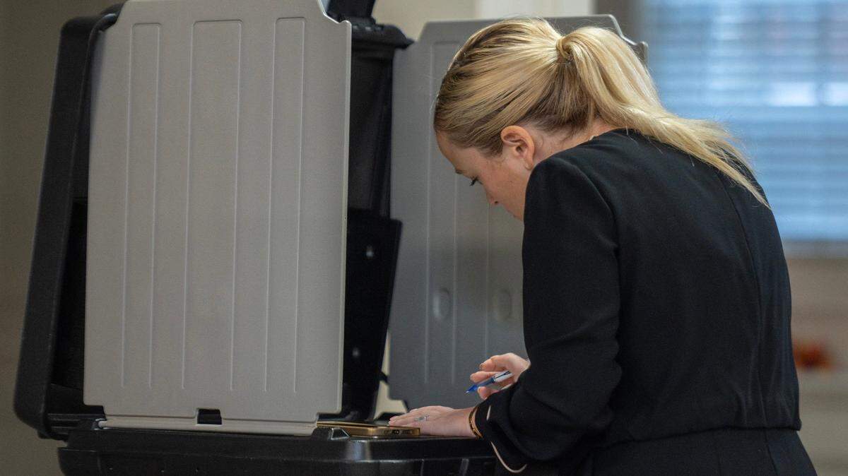 A voter casts their ballot at Asbury United Methodist Church on Tuesday, Nov. 7, 2023, in Prairie Village.