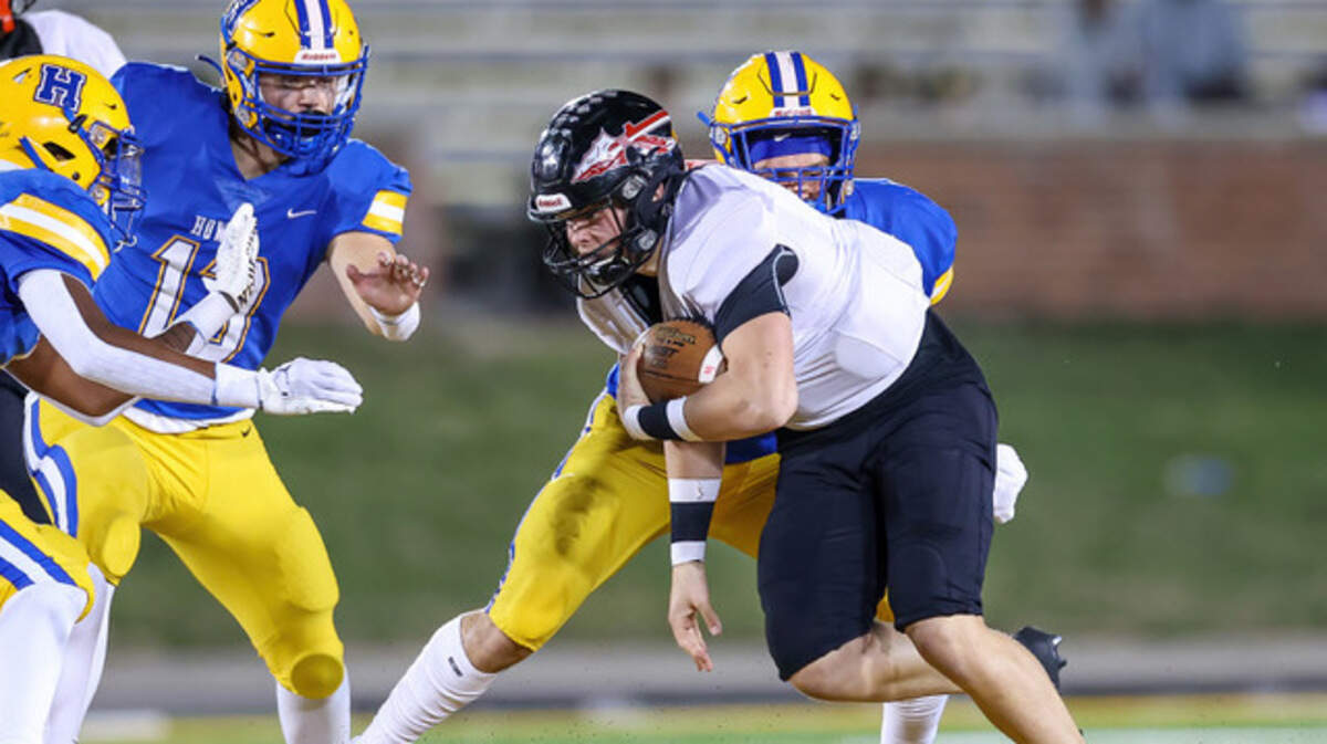 Fort Osage quarterback Greg Menne is bottled up by the Francis Howell defense during the Vikings’ 49-21 win over the Indians in the Missouri Class 5 championship game Friday night in Columbia.