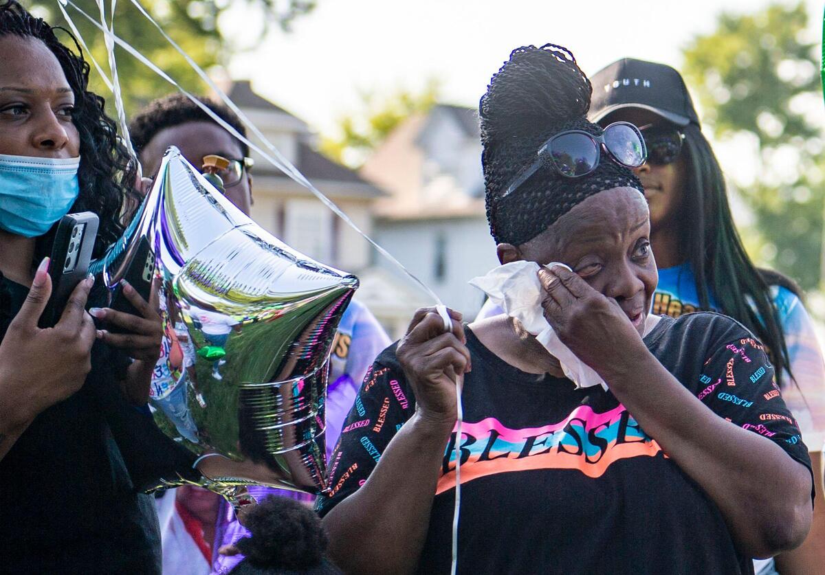 Friends and family members listen to Quiana Martin speaks about the life of her mother, Shirley Muhammad during the vigil to celebrate her life and the lives of Jaelin Ransom and Tyla Ransom, Thursday, July 29, 2021 at Stanford Brown Park in Kansas City. Friends and family gathered to let go of balloons and celebrate their loved ones lives.