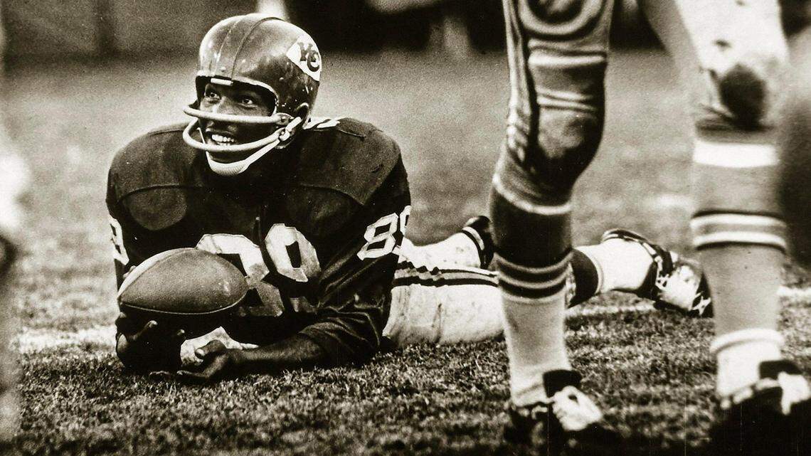 Kansas City Chiefs wide receiver Otis Taylor smiles after making a catch during a muddy game. Today, Taylor, 79, is bedridden in the care of his close family.