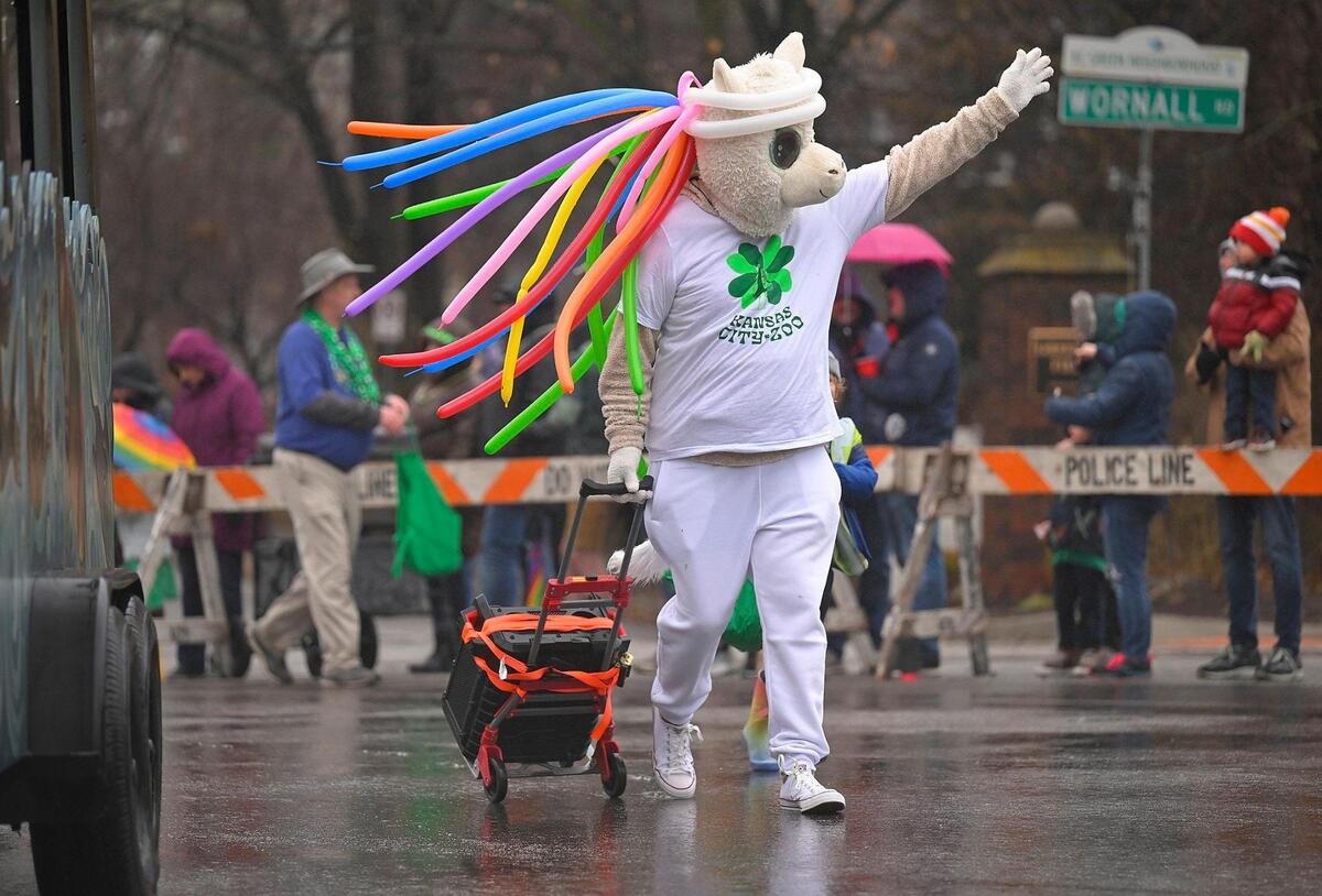 A mascot from the Kansas City Zoo waved to the crowd during the 2023 Brookside St. Patrick’s Day Warm-Up Parade on Saturday March 11, 2023 in Kansas City.