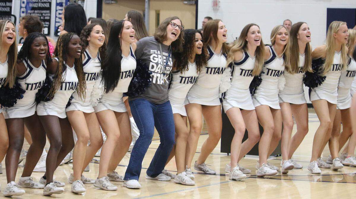 Lee’s Summit West High School teacher Jennifer Jones celebrates being named the 2025 teacher of the year for Missouri alongside a group of the school’s cheerleaders Thursday afternoon.