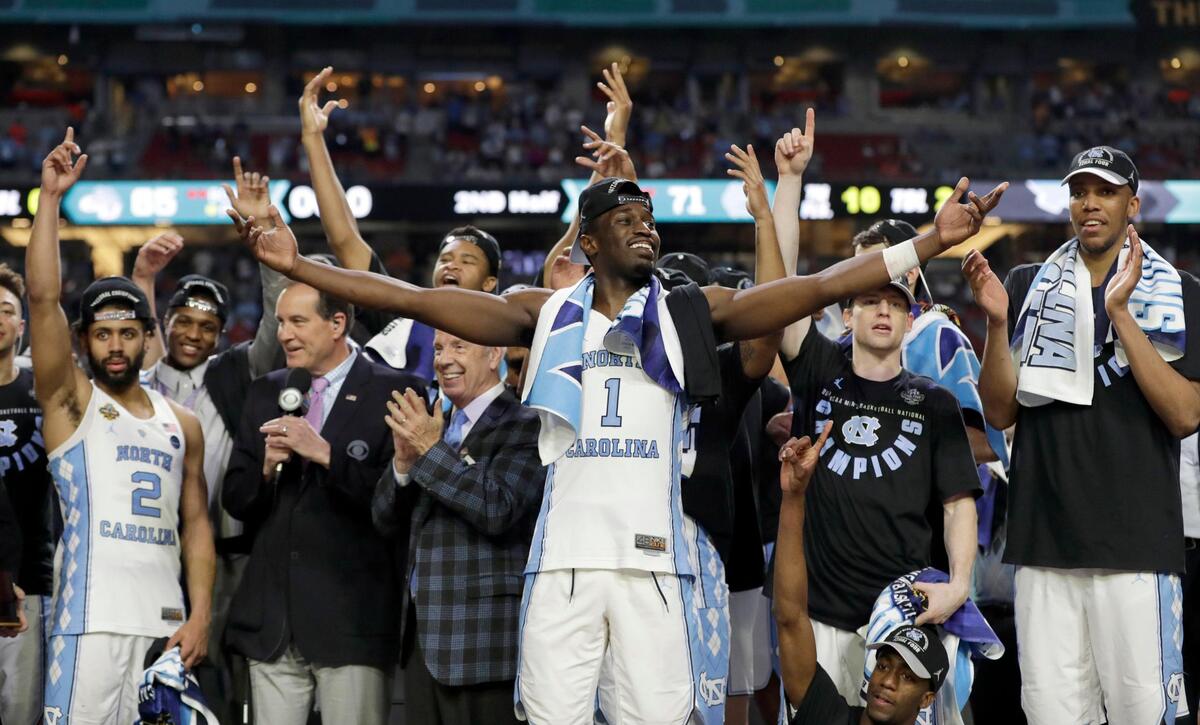 North Carolina’s Theo Pinson (1), coach Roy Williams and the rest of the team celebrate after the championship game against Gonzaga at the 2017 Final Four NCAA college basketball tournament in Glendale, Ariz. North Carolina won 71-65.