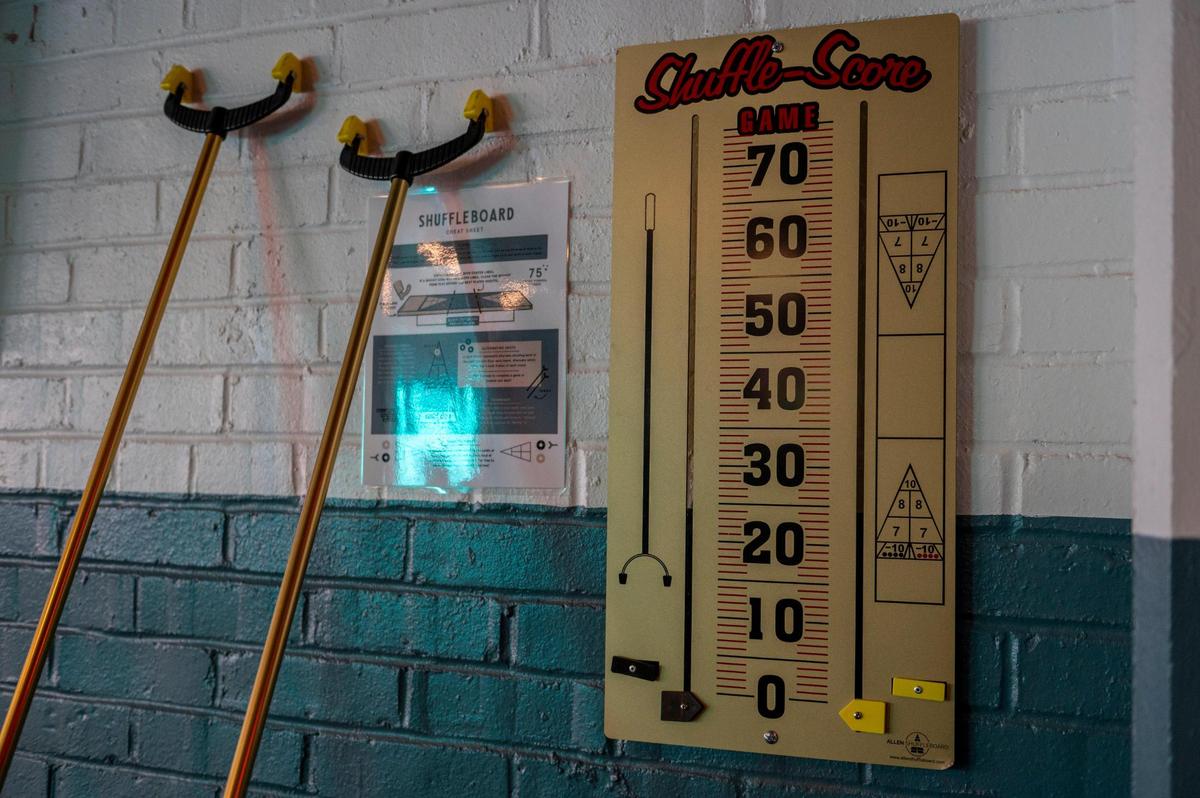 Players can use a shuffleboard scoreboard to keep track of their points.