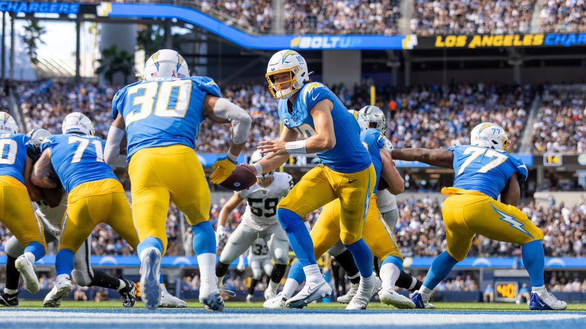 Quarterback (10) Justin Herbert of the Los Angeles Chargers turns to hand off against the Las Vegas Raiders in an NFL football game, Sunday, Sept. 11, 2022, in Inglewood, Calif. Chargers won 24-19. (AP Photo/Jeff Lewis)