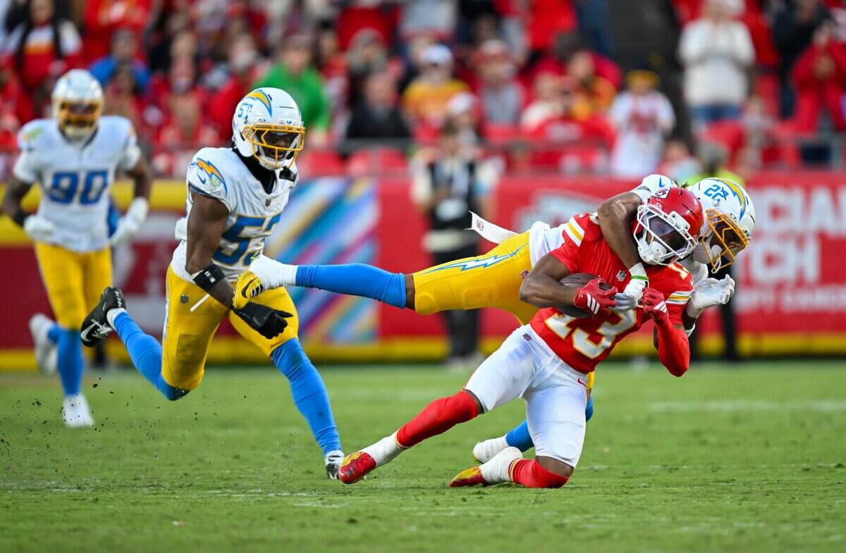 Kansas City Chiefs wide receiver Cyrus Allen (13) is tackled by Los Angeles Chargers safety R.J. Mickens (27) in the Kansas City Chiefs vs. Los Angeles Chargers NFL regular season game at Arrowhead Stadium in Kansas City on Oct. 18, 2026.