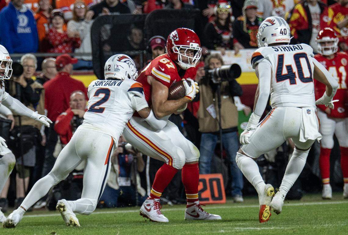 Kansas City Chiefs tight end Travis Kelce (87) with a catch in front of Denver Broncos cornerback Pat Surtain II (2) during the first half of the game at GEHA Field at Arrowhead Stadium on Thursday, Dec. 25, 2025, in Kansas City. 