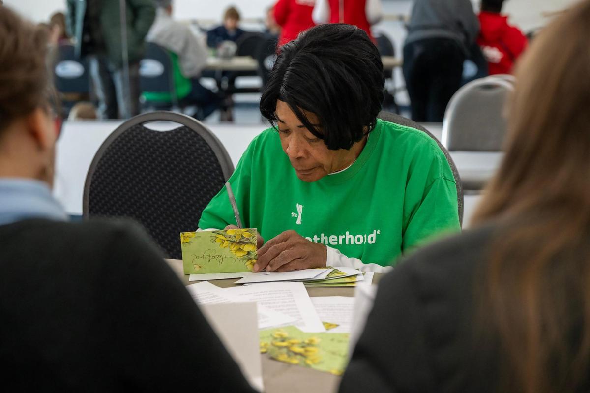 Palmer Mason wrote cards of encouragement for students, veterans, and neighbors facing food insecurity during the MLK Day of Service on Monday, Jan. 20, 2025, at the Cleaver Family YMCA in Kansas City.