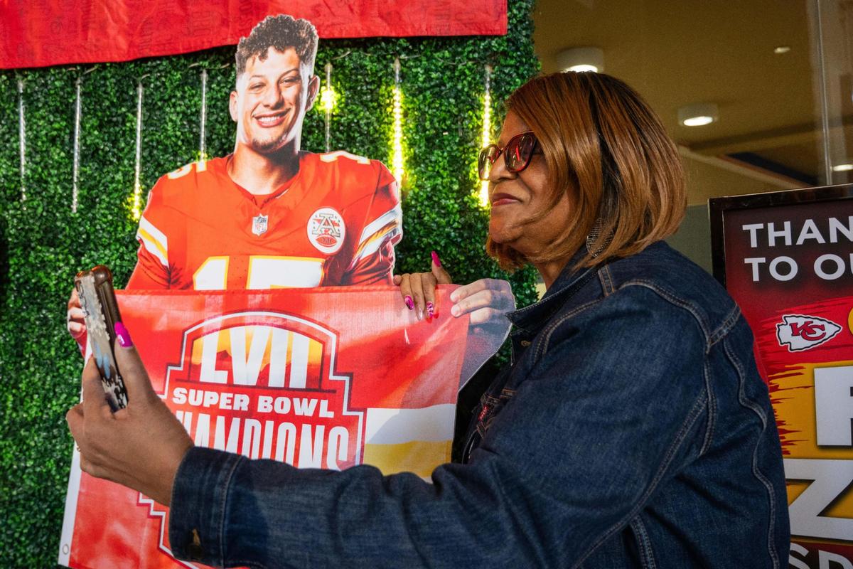 Benita Townsend-Young takes a selfie with a cutout of Patrick Mahomes at the Chiefs Fan Zone at Union Station in Kansas City on Thursday, Jan. 16, 2025.