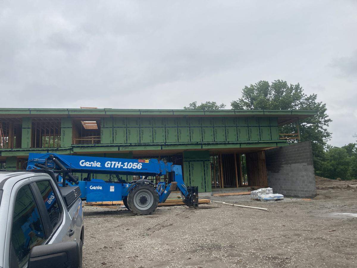 The north side of the modern, nearly 10,000-square-foot mansion under construction in May at 6315 Ward Parkway as seen from West 63rd Street. The upper floor, cantilevered over a privacy wall, can be seen at right.