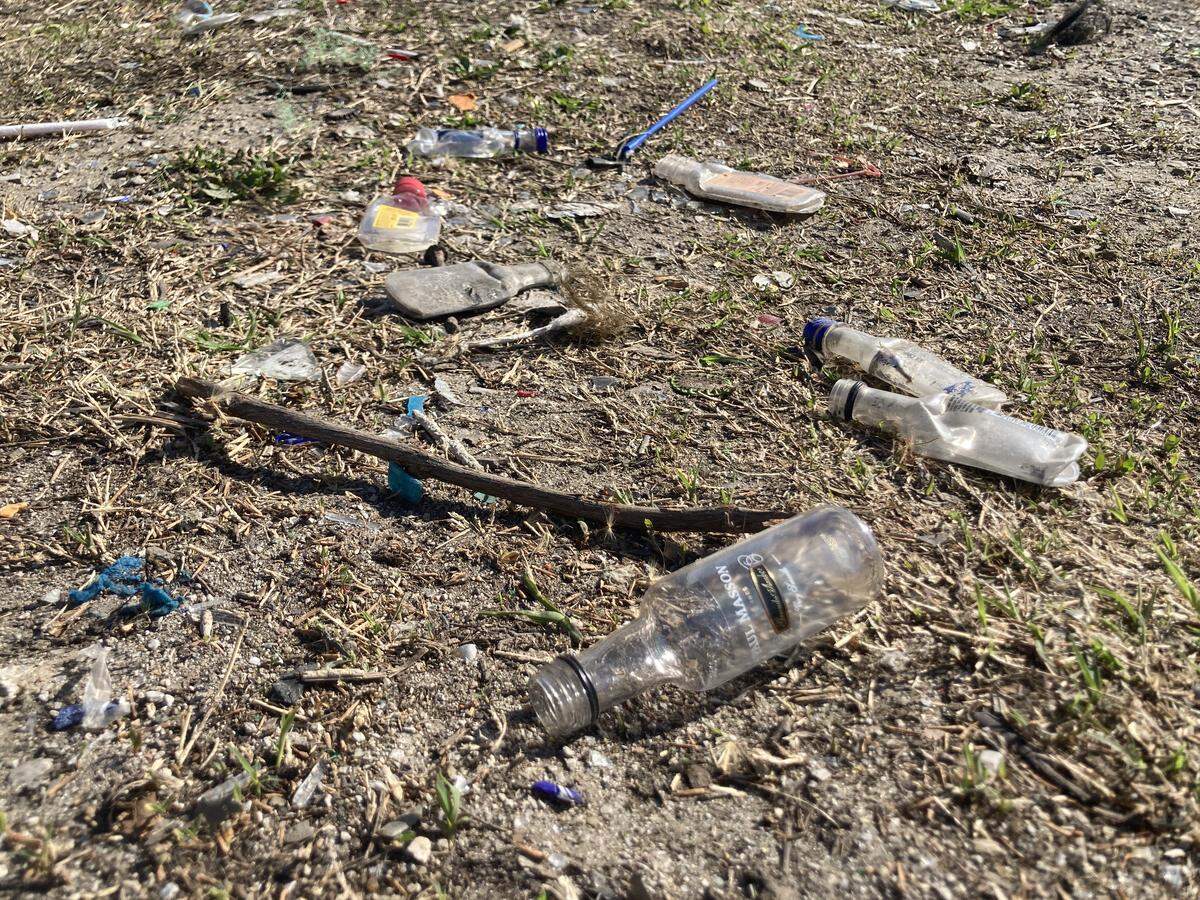 Mini 50-milliliter liquor bottles litter the ground outside Big D’s Conven & Grocery at 35th Street and Prospect Avenue.