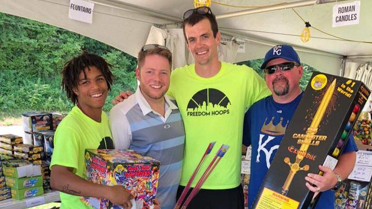 Freedom Hoops executive director Michael Loney, center, spent time with customers this week at the organization's yearly Fourth July fireworks sale.