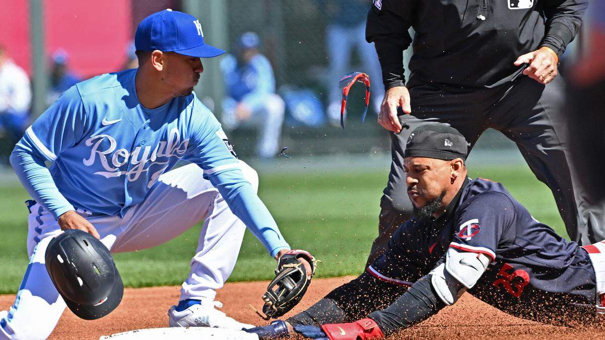 Minnesota Twins designated hitter Byron Buxton (25) dives into second base with a double during the first inning against Kansas City Royals second baseman Nicky Lopez (8) at Kauffman Stadium.