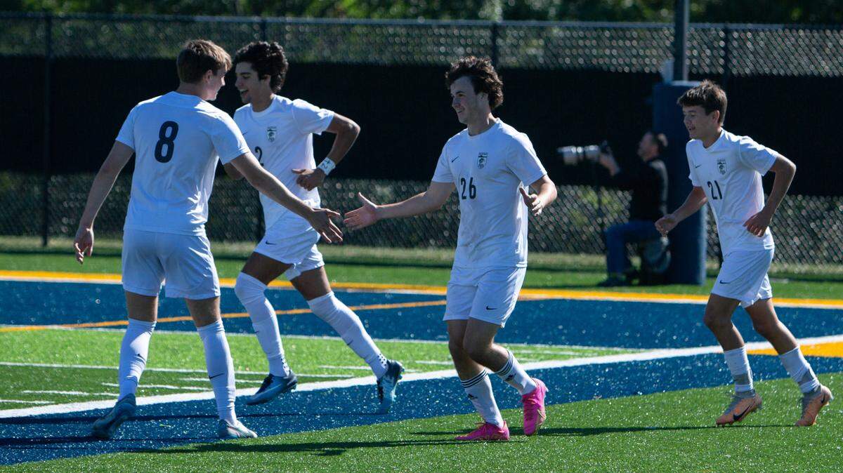Park Hill South’s Quinlan McNellis (No. 26) celebrates with teammates after the first of two goals in the 810 Varsity Showcase on Saturday.