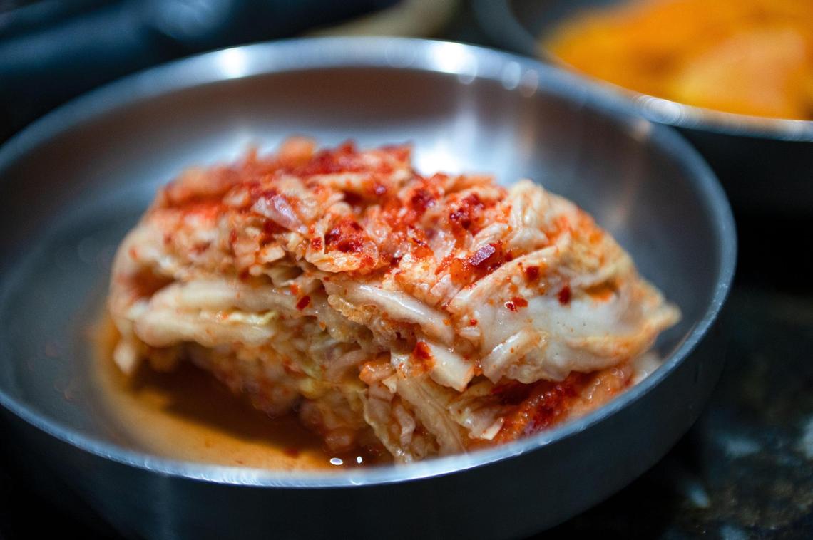 A side dish of kimchi is made with brined cabbage, spices, green onion, fish sauce and other ingredients that give it its pungent, refreshing flavor.