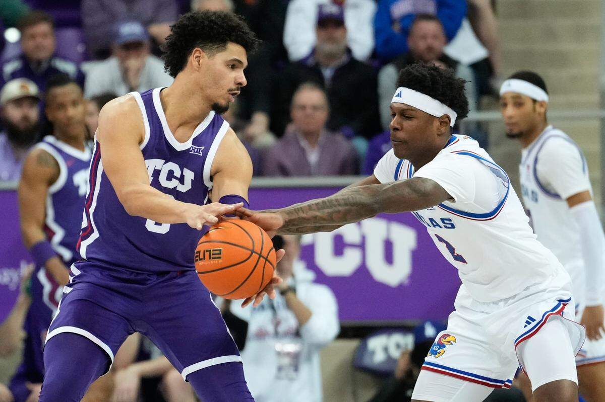 Kansas Jayhawks guard AJ Storr (2) steals the ball from TCU Horned Frogs guard Brendan Wenzel (0) during the second half at Ed and Rae Schollmaier Arena on Jan. 22, 2025.