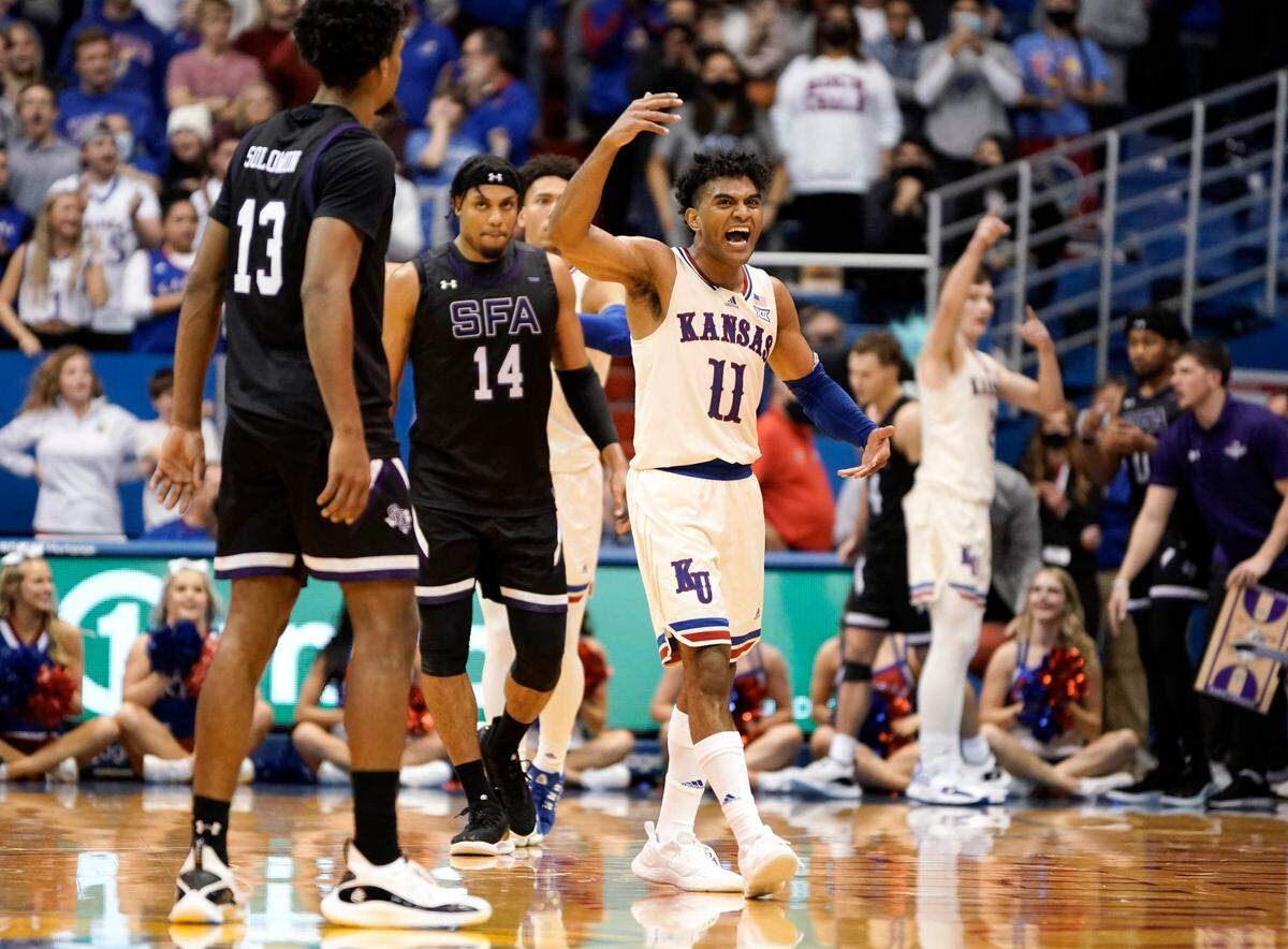 Fired up, Kansas guard Remy Martin (11) pumps up the Allen Fieldhouse crowd after hitting a late three-pointer to extend the Jayhawks’ lead over Stephen F. Austin on Saturday, Dec. 18, 2021.