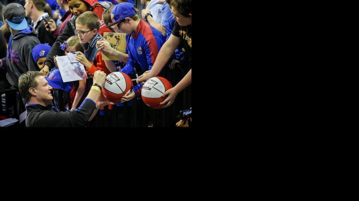 
University of Kansas Jayhawks men's basketball head coach Bill Self signed autographs for young fans following the team's practice at CenturyLink Center in Omaha on Thursday afternoon. Kansas begins their NCAA tournament Friday morning against New Mexico State.
