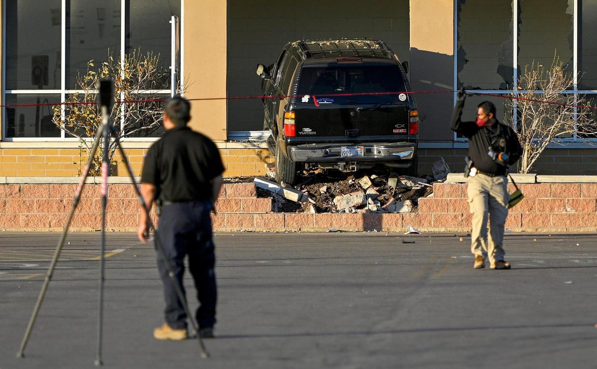 A driver crashed into the front wall of the Walmart Supercenter in the Plaza at the Speedway shopping center in Kansas City, Kansas, Thursday, Dec. 2, 2021. Two people were injured and one was killed.