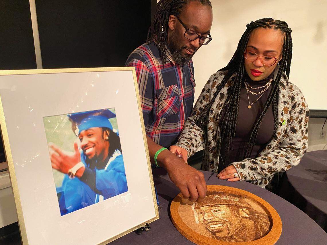 Carthesa and Christopher Hutson Sr., of Lee’s Summit, who lost their son, Christopher, in a road rage incident in 2017, put the finishing touches on a floral portrait of him that will be featured on a float in the Rose Parade on New Year’s Day.