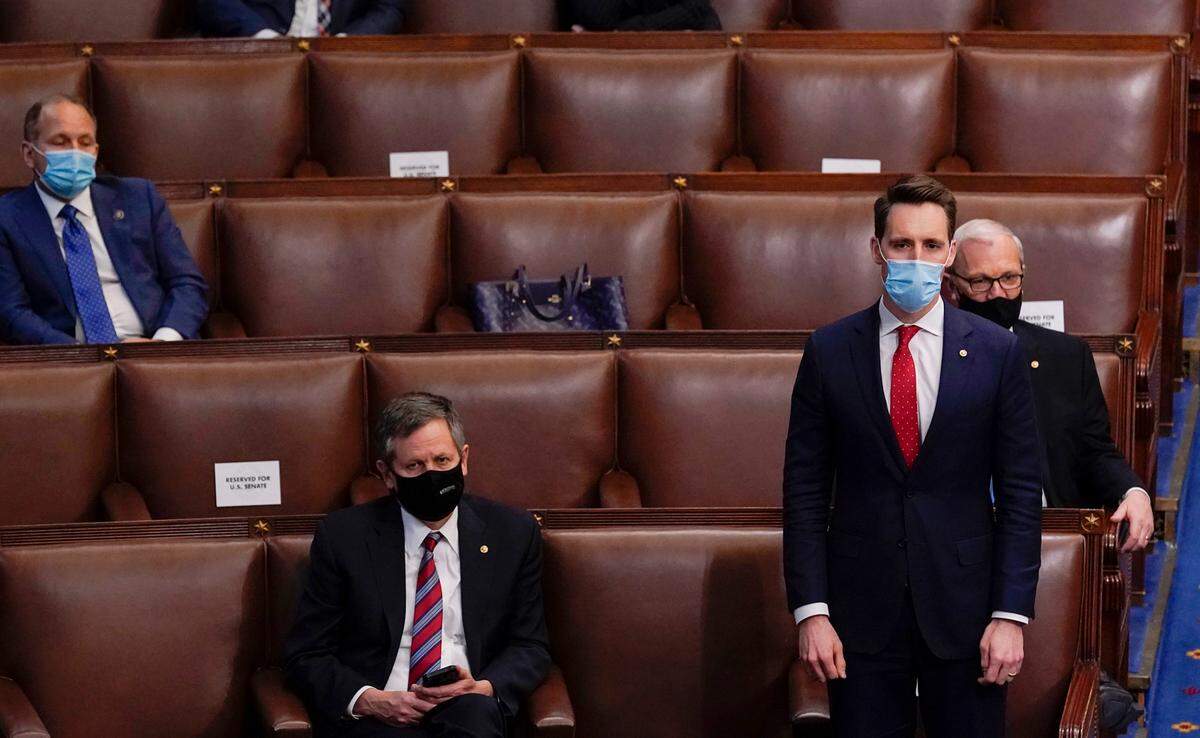 Sen. Josh Hawley rises to join House Republican members objecting to confirming the Electoral College votes from Pennsylvania during a joint session of the House and Senate. The session was held to confirm the Electoral College votes cast in November’s election, at the Capitol, early Thursday, Jan 7, 2021, in Washington.