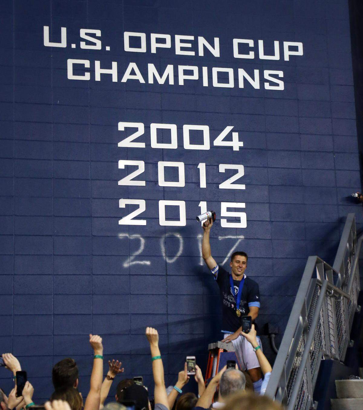Sporting Kansas City defender Matt Besler (5) commemorates the 2017 U.S. Open Cup championship after defeating the New York Red Bulls at Children’s Mercy Park on Sept. 20, 2017.