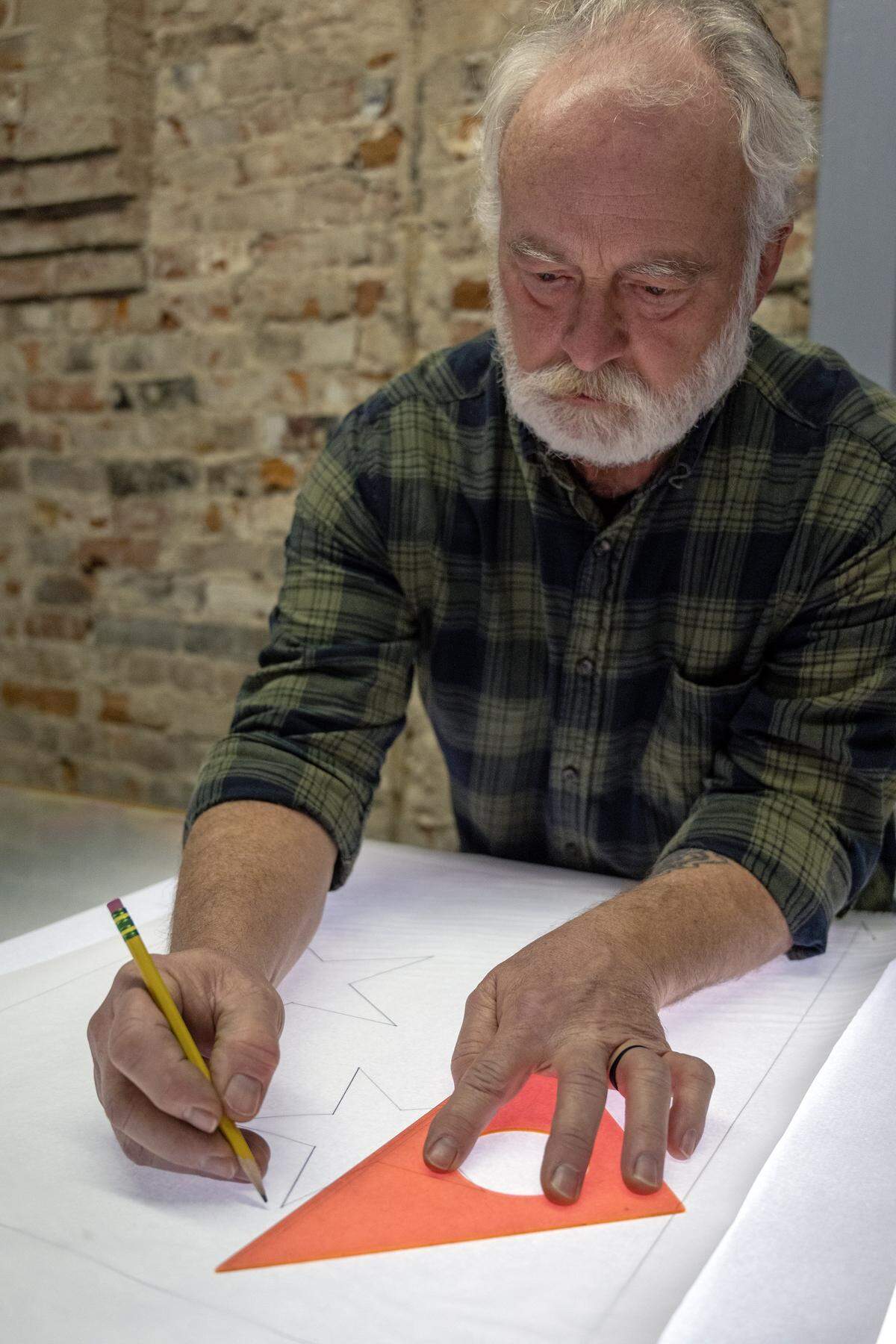 Randy Carney pencils out the stars on white fabric to make a flag of Curaçao on Thursday, Jan. 8, 2025, at All Nations Flag Co., in Kansas City. Curacao is the smallest country participating in the FIFA World Cup matches in Kansas City this summer. The local flag company will be making and stocking flags for the teams participating in this years' World Cup.