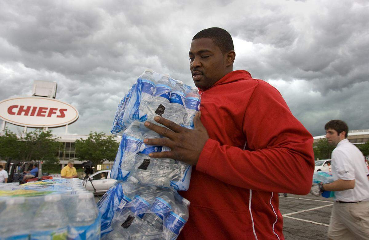 Former Kansas City Chiefs Duane Clemons unloaded bottled water outside Arrowhead Stadium on Tuesday afternoon. Clemons and other Chiefs ambassadors, employees, and a few cheerleaders from the Chiefs were on hand to collect donations that will be delivered to the tornado ravaged city of Joplin. Donations of cash, or bottled water will be accepted in Lot C at Arrowhead Stadium until 7 p.m. Tuesday and all day on Wednesday, May 25, 2011. Monetary donations will go to Heart to Heart International to aid tornado victims in Reading, Kan., and Joplin, Mo. Fry-Wagner Moving and Storage was donating the water transportion to Joplin.