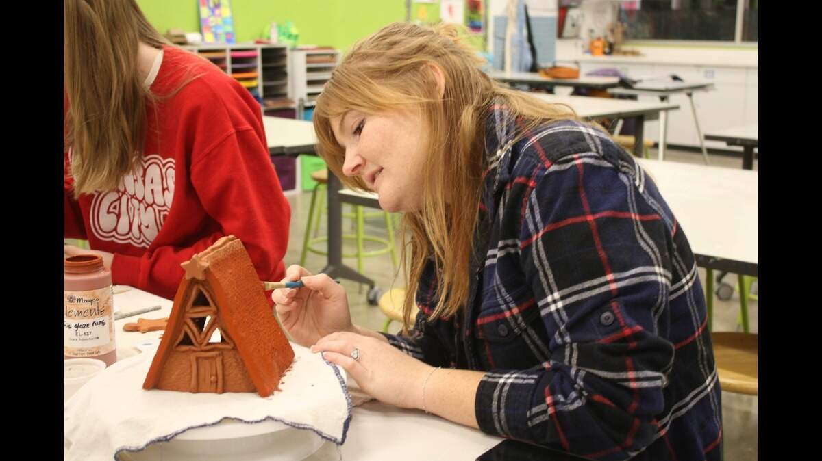 Prairie Village resident Madilyn Mills paints her ceramic gingerbread house during an art class at the Johnson County Arts and Heritage Center.