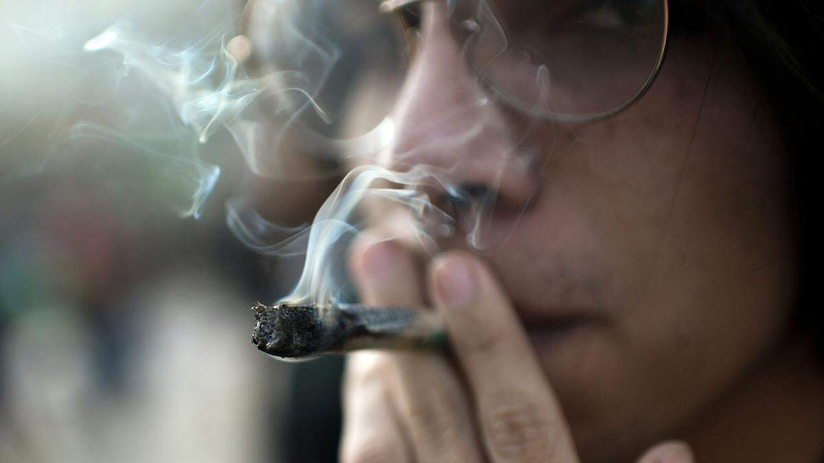 A man smokes a joint during the International Marijuana Day celebration at the Almagro Park, in Santiago on April 20, 2023. (Photo by Pablo VERA / AFP) (Photo by PABLO VERA/AFP via Getty Images)