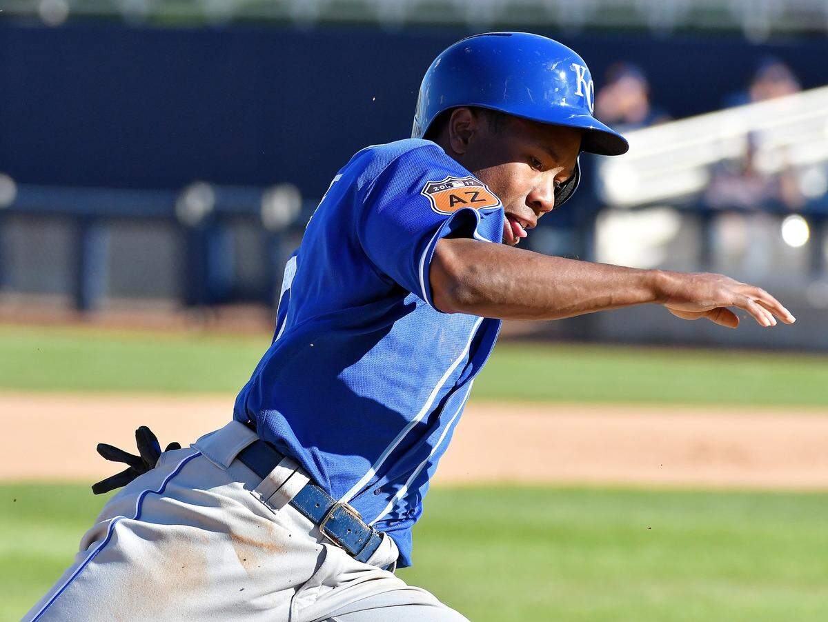 Royals outfielder Terrance Gore, shown racing home on a hit by Hunter Dozier during a February 2017 spring training game against the Brewers, was known for his speed on the basepaths and infectious smile and personality in the clubhouse and dugout.