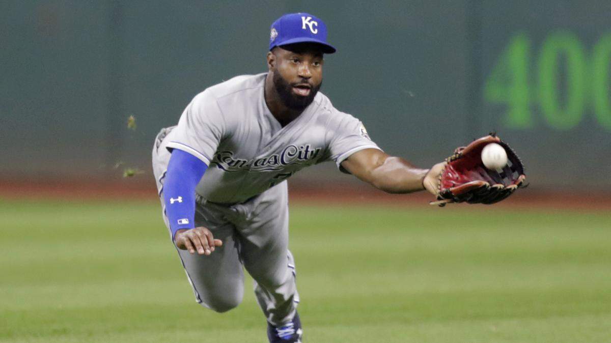 Kansas City Royals’ Brian Goodwin dives for the ball hit by Cleveland Indians’ Brandon Guyer in the fourth inning Tuesday night in Cleveland. Guyer was out on the play.