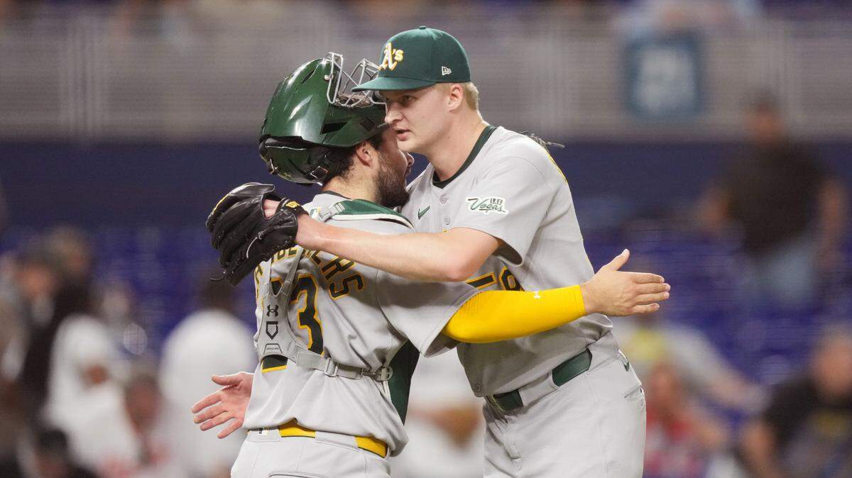 Athletics pitcher Noah Murdock (58) congratulates catcher Shea Langeliers (23) on a victory against the Miami Marlins at loanDepot Park on May 2, 2025.