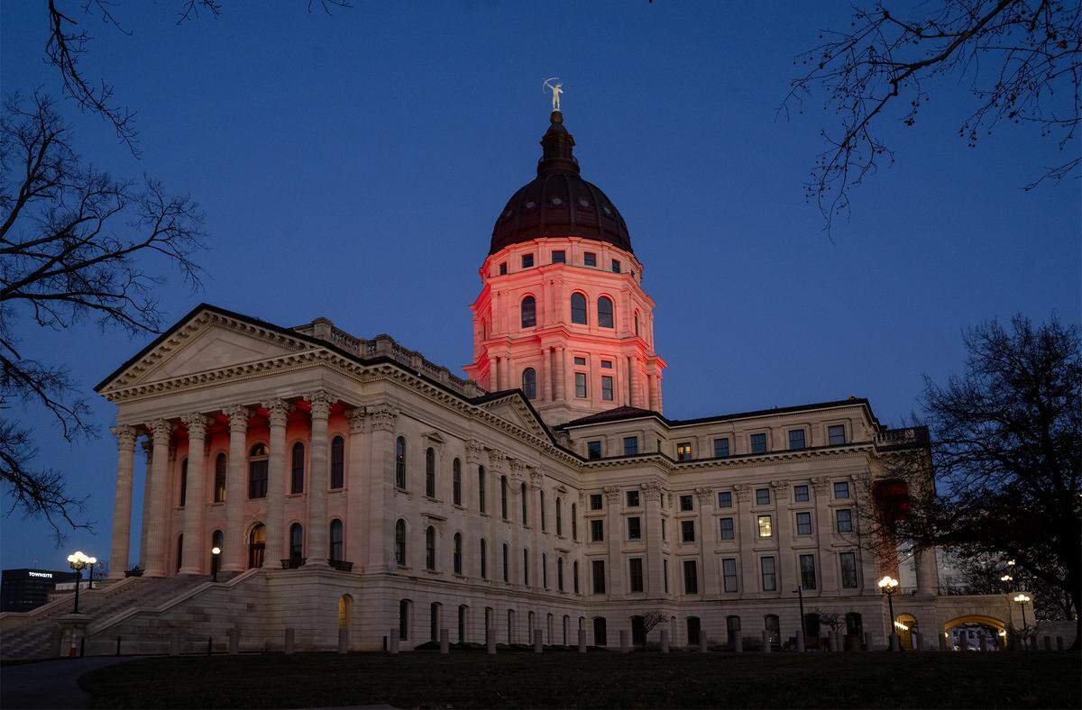 The Kansas Statehouse is bathed in red light after Kansas Gov. Laura Kelly announced Monday, Dec. 22, that the Kansas City Chiefs will build their new stadium in Kansas City, Kansas. The decision marks a major win for the state, bringing one of the region’s most prominent sports teams across the state line.