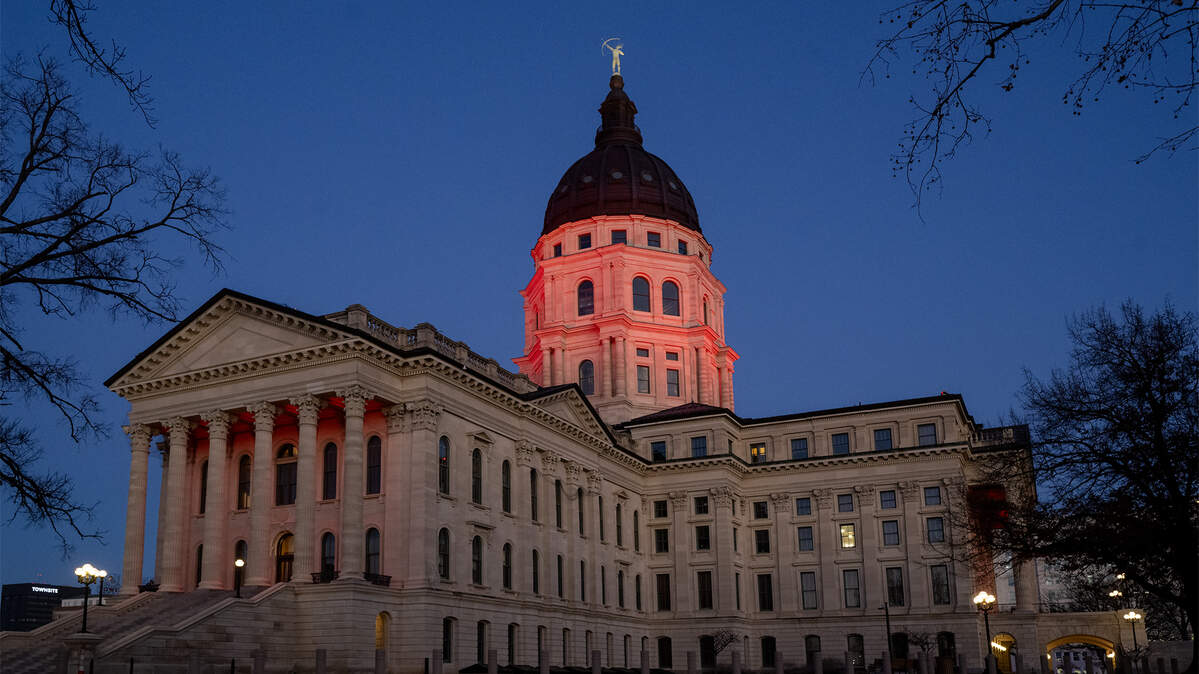 The Kansas Statehouse is bathed in red light after Kansas Gov. Laura Kelly announced Monday, Dec. 22, 2025, that the Kansas City Chiefs will build their new stadium in Kansas City, Kansas. The decision marks a major win for the state, bringing one of the region’s most prominent sports teams across the state line.