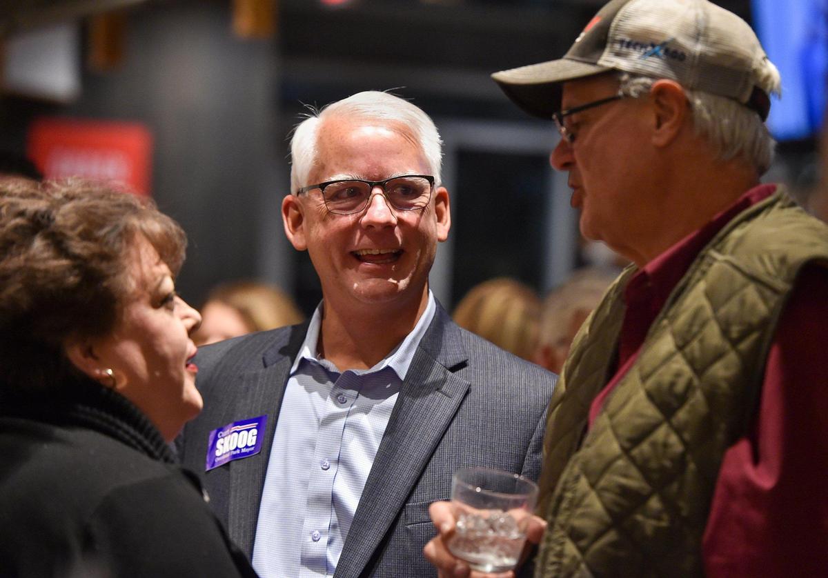 Overland Park mayoral candidate Curt Skoog, center, chats with supporters Liz and John Hochscheid at Skoog’s watch party Tuesday at Strang Hall in downtown Overland Park. Skoog, a longtime city councilman, faced retired AMC Theatres executive Mike Czinege in the race.