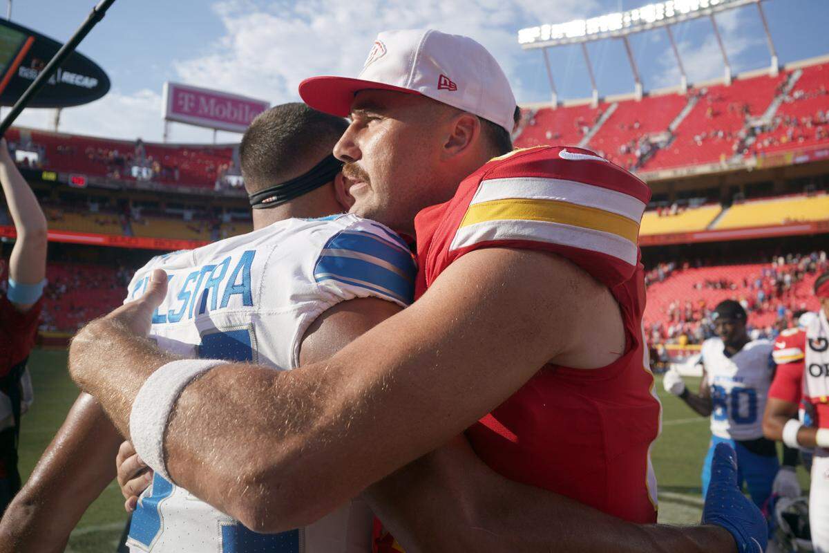 Kansas City Chiefs tight end Travis Kelce (87) embraces Detroit Lions tight end Shane Zylstra (84) after the game at GEHA Field at Arrowhead Stadium.