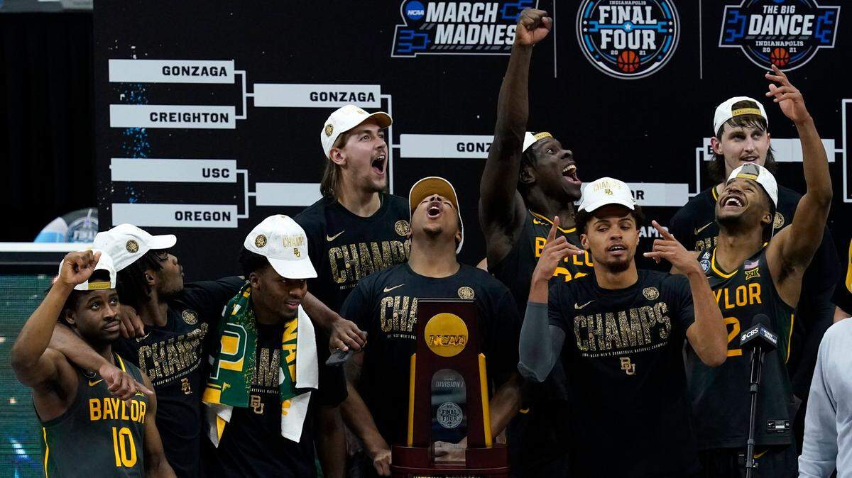 Baylor players celebrate with the trophy after their championship-game win against Gonzaga in the NCAA Tournament finale Monday night at Lucas Oil Stadium in Indianapolis.