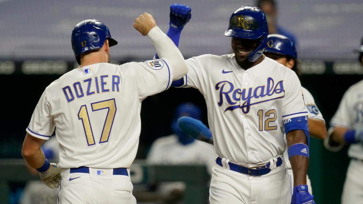 Kansas City Royals Hunter Dozier (left) is congratulated by teammate Jorge Soler after Dozier’s two-run home run during the seventh inning against the Minnesota Twins at Kauffman Stadium in Kansas City, Mo., Friday, Aug. 21, 2020.