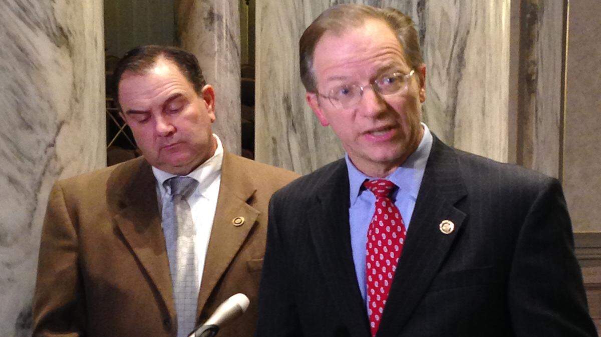 Missouri Sen. Bob Onder talks with reporters Wednesday, March 9, 2016, at the Capitol in Jefferson City, Mo., as Senate Majority Leader Mike Kehoe looks downward following a 37-hour-long debate. Republicans halted a Democratic filibuster Wednesday and then voted to give initial approval to a proposed constitutional amendment sponsored by Onder. The measure would prohibit government penalties against some businesses and individuals who cite religious beliefs while declining to provide wedding-related services to same-sex couples. 