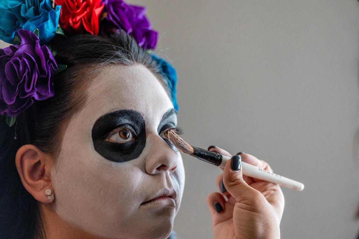 Briiones applies makeup around Yulissa Lopez’s eyes as she is transformed into the Catrina.