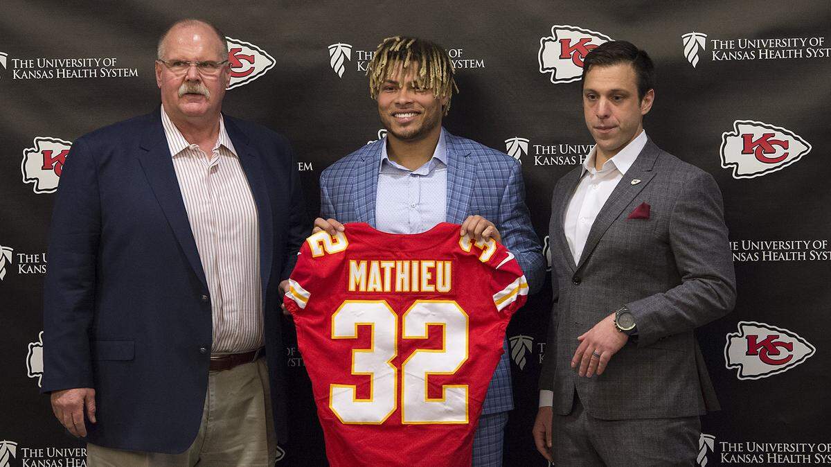 Chiefs coach Andy Reid, left, and general manager Brett Veach flank newly signed safety Tyrann Mathieu on Thursday in Kansas City.