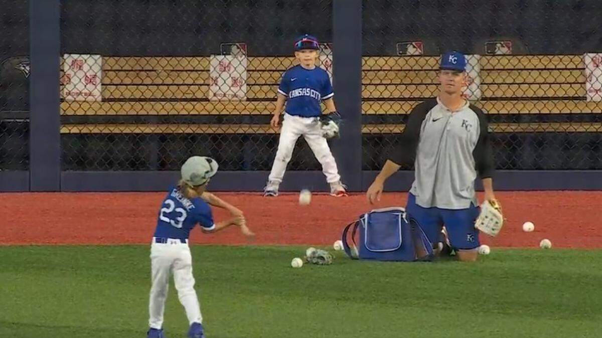Zack Greinke playing ball with his sons before a Royals game in Toronto.