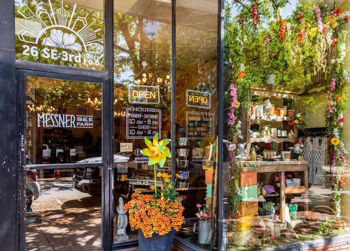 The sunlight shines on the Messner Bee Farm storefront in downtown Lee’s Summit.