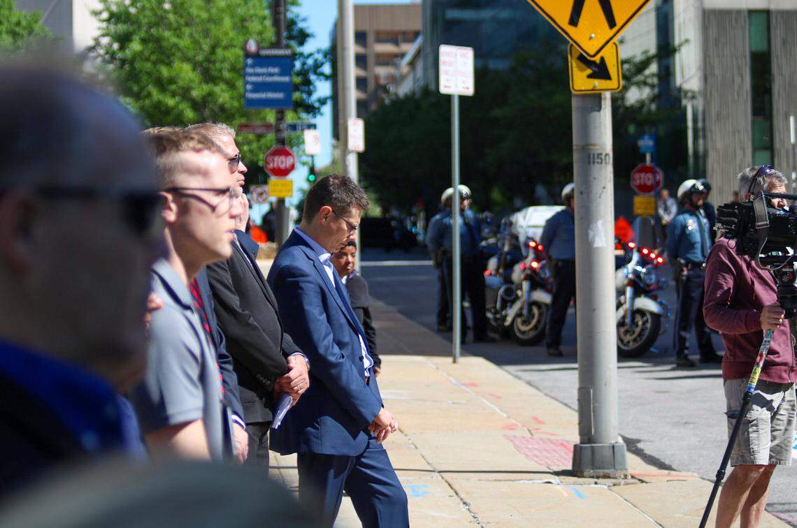 A man bows his head as the names of fallen Kansas City police officers are read May 9, 2024. Dozens of community members and law enforcement personnel lined the sidewalks outside KCPD headquarters at 1125 Locust Street.