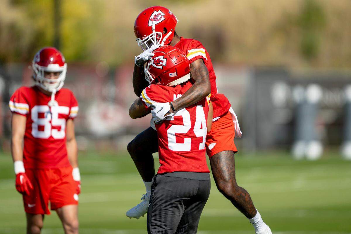 Kansas City Chiefs wide receiver Mecole Hardman (12) jumps on wide receiver Skyy Moore (24) during a team practice on Thursday, Oct. 19, 2023, in Kansas City.