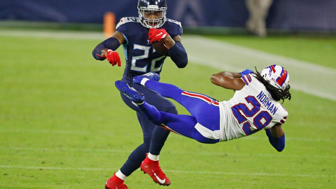 Tennessee Titans running back Derrick Henry (22) knocks down Buffalo Bills cornerback Josh Norman (29) in the first half of an NFL football game Tuesday, Oct. 13, 2020, in Nashville, Tenn. (AP Photo/Wade Payne)