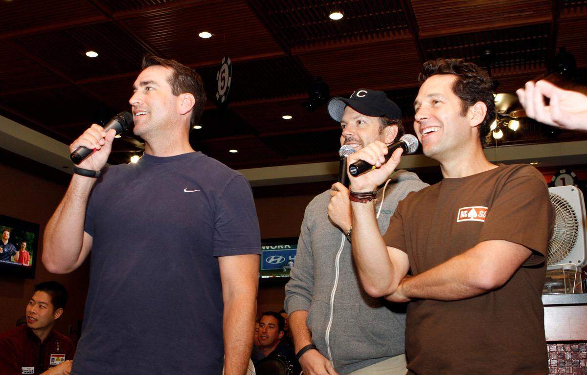 Rob Riggle, left, Jason Sudeikis, center and Paul Rudd host the Big Slick Poker Tournament in 2012.